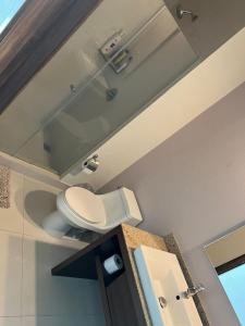 a bathroom with a toilet and a mirror on the ceiling at Penthouse Minerva in Guadalajara