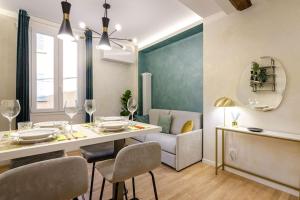 a kitchen and living room with a table and chairs at Portanova Luxury Home in Bologna