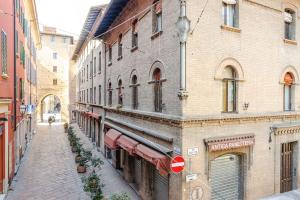 una calle vacía en un viejo edificio con una señal de stop en Portanova Luxury Home en Bolonia