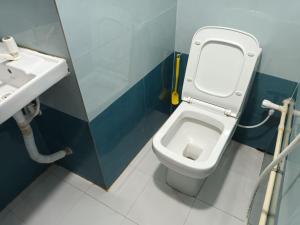 a bathroom with a toilet and a sink at GOVARDHAN HOME STAY ( Munna ) in Guwahati