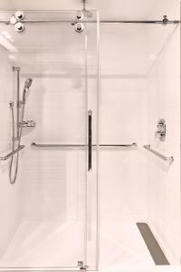 a shower with a glass door in a bathroom at AC Hotel by Marriott Nashville Brentwood in Brentwood