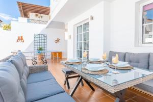 a living room with a table and a couch at Casa Laura in Puerto del Carmen