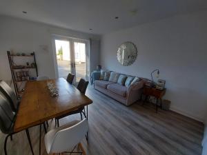 a living room with a table and a couch at The T House in Bushmills