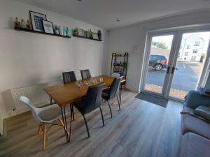 a dining room with a wooden table and chairs at The T House in Bushmills