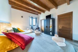 a bedroom with two beds with red and yellow pillows at Agriturismo Tenuta del Grillaio in Acquaviva delle Fonti