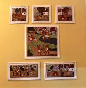a group of framed pictures on a wall at OKE Apart Hotel in San Lorenzo