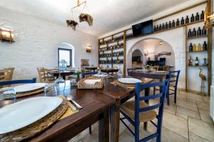 a dining room with a large wooden table and chairs at Agriturismo Tenuta del Grillaio in Acquaviva delle Fonti