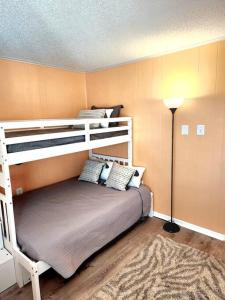 a bedroom with two bunk beds and a lamp at Spacious 2 Bedroom and 2 Baths in Ocean City