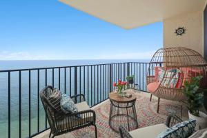 a balcony with chairs and a view of the ocean at Sapphire Oasis- Heavenly Ocean View and Resort in Kahana