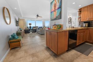 a kitchen with a counter and a living room at Sapphire Oasis- Heavenly Ocean View and Resort in Kahana