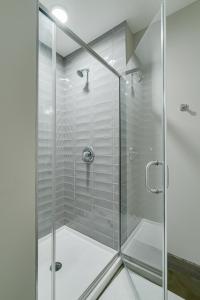 a shower with a glass door in a bathroom at Sable 82 in Minneapolis