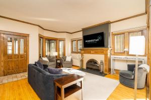 a living room with a couch and a fireplace at Harriet House in Minneapolis