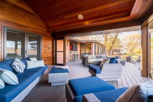 a screened in porch with blue couches and chairs at The Lakeview in Red Wing