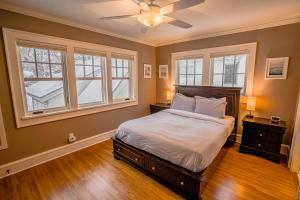 een slaapkamer met een bed en 2 ramen bij Kenilworth Place in Minneapolis