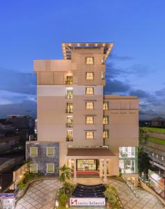 a rendering of a hotel building at dusk at Swiss-Belhotel Tarakan in Tarakan