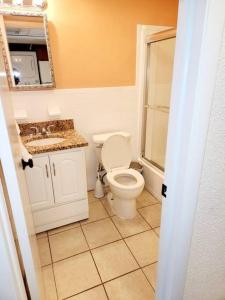 a bathroom with a toilet and a sink at Beachfront Condo In Paradise in Ocean City