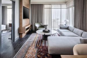 a living room with a couch and a table at Marriott Dallas Uptown in Dallas +73 photos