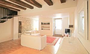 a living room with a white couch and a table at Maison de LOlivier, Beautiful Townhouse with Private courtyard in Eymet