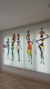 a group of woman paintings on a wall in a museum at Joa Guesthouse in Gwangju