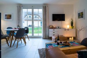 a living room with a couch and a table at Ferienhaus Greta in Glowe