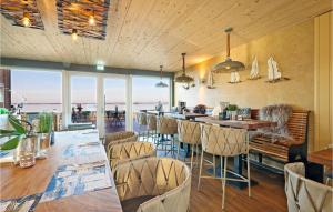 a restaurant with chairs and a bar with a view at Pet Friendly Apartment in Lembruch