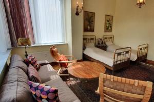 a living room with a couch and a table at Ferienwohnungen Villa Haniel Carl in Dresden