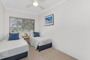 a bedroom with two beds and a window at Longbeach Unit 12 in Gold Coast