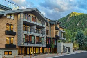 an apartment building with a mountain in the background at The Sky Residences at W Aspen in Aspen