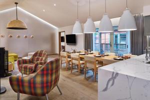 a dining room with a table and chairs at The Sky Residences at W Aspen in Aspen