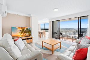 a living room with white furniture and a view of the ocean at Royal Palms 24 F in Gold Coast