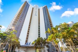 a tall white building with palm trees in front of it at Royal Palms 24 F in Gold Coast