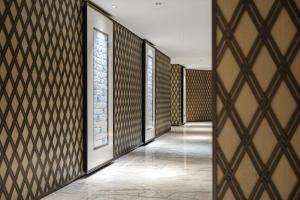 a hallway with doors and windows and a tile floor at Radisson Collection Hotel, Yangtze Shanghai in Shanghai