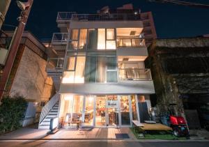 a building with a store in front of it at night at Glamping Tokyo Asakusa in Tokyo