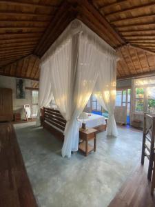 a bedroom with a bed with a canopy at Sarini Villas in Blahbatu