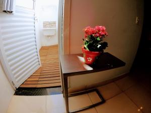 a potted plant sitting on a table in a room at Pousada Ideal Guarujá - Estúdios Família & Quartos in Guarujá +38 photos