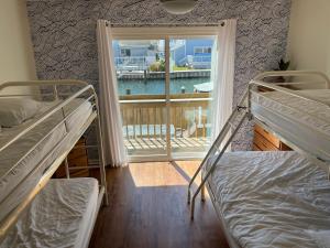 two bunk beds in a room with a window at Ocean City, MD Waterfront Villa in Ocean City