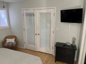 a bedroom with a bed and a flat screen tv at Ocean City, MD Waterfront Villa in Ocean City