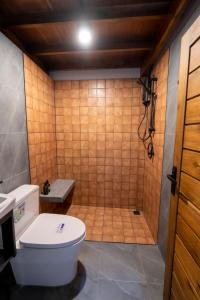 a bathroom with a toilet and a shower at Makai NAP in Ban Lam Pi