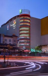 a building with a sign on the side of it at Ibis Styles Jakarta Mangga Dua Square in Jakarta