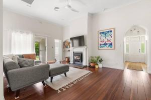 a living room with a couch and a fireplace at Piambong House in Clare