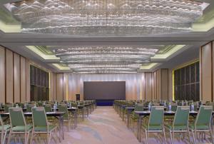 a conference room with tables and chairs and a screen at The Westin Qingdao - Instagrammable in Qingdao +109 photos