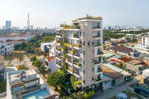 um prédio de apartamentos com plantas em uma cidade em Royal 98 Hotel & Apartment em Da Nang