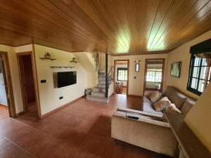 a living room with a couch and a tv at Eira Vella Bueu in Bueu
