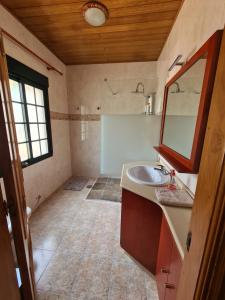 a bathroom with a sink and a mirror at Eira Vella Bueu in Bueu +25 photos