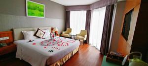 Postel nebo postele na pokoji v ubytování Dendro Gold Hotel