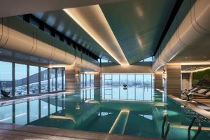 a swimming pool in a building with a view at Primus Hotel Shanghai Hongqiao in Shanghai
