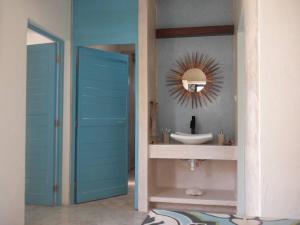a bathroom with a sink and a mirror at Casa Tulup Sisal in Sisal +18 photos