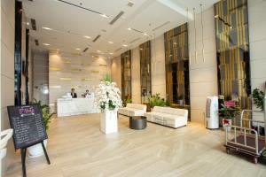 a lobby with couches and flowers in a building at Grand Ocean Luxury Boutique in Da Nang