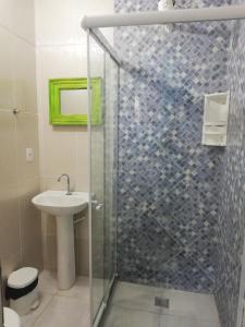 ein Bad mit einer Glasdusche und einem Waschbecken in der Unterkunft Casa dos franceses guesthouse ilha grande in Abraão