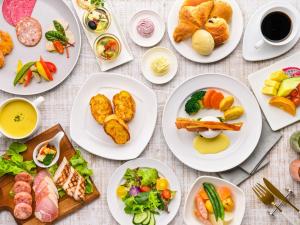 a table with plates of food on it at Hotel Nikko Alivila in Yomitan